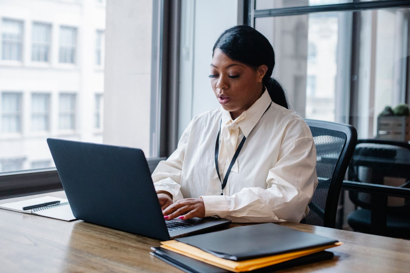 A finance officer matching invoices at a computer