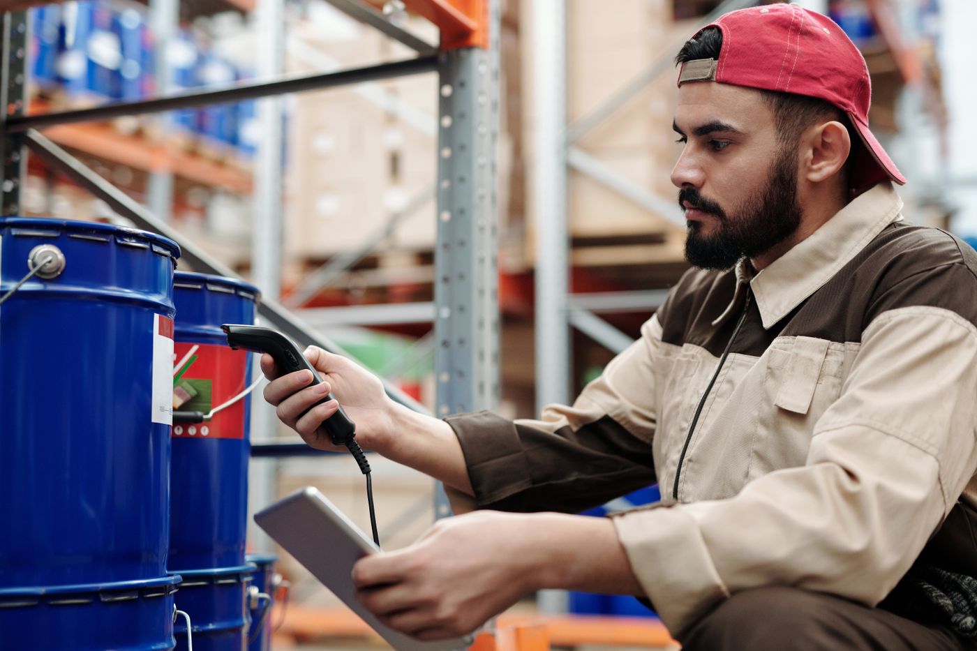 A warehouse worker checking a delivery against a tablet