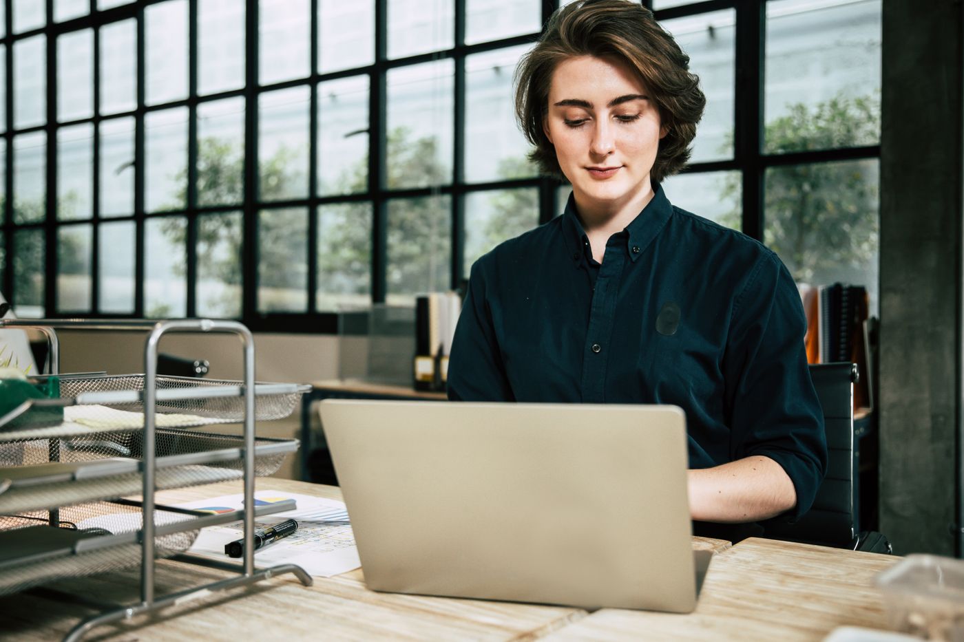 A member of staff raising a request at a laptop