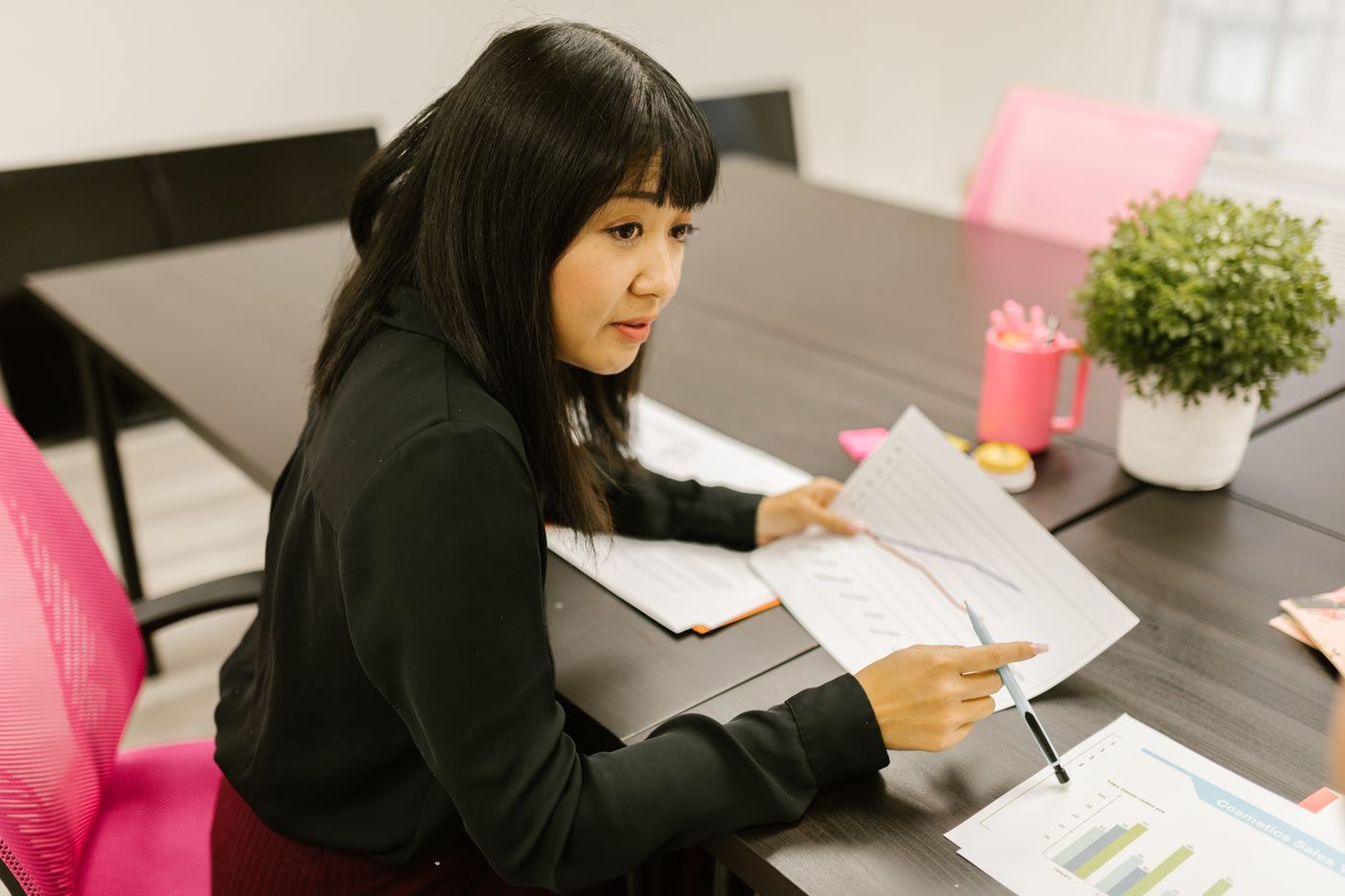 A procurement officer checking supplier documents at a desk